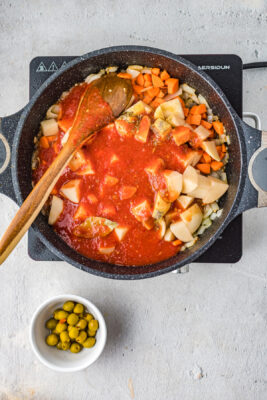 Tomato puree poured into the skillet.