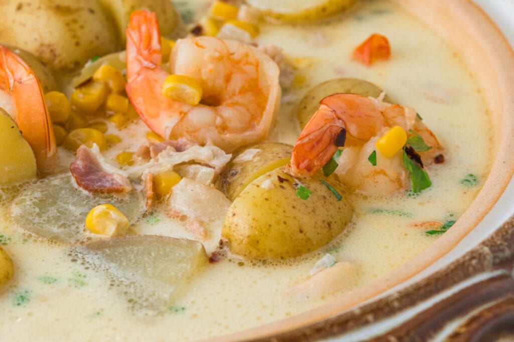 close up off center image of a shrimp potato and corn chowder.