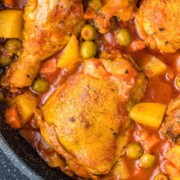 Seasoned chicken in a sauce mixed with olives, potatoes and carrots.