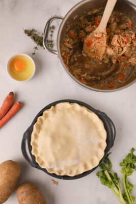 The second dough pie is placed on top of the pie. the seams are sealed.