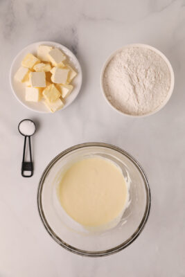 Sour cream and eggs combined in a bowl.