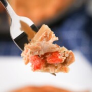 A piece of smoked chicken pot pie being held by a fork.