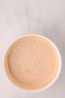 Buffalo ranch wing sauce in a white bowl on the table.