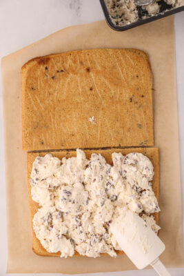 Ice cream is added to the top of the cookie and spread into a thin layer.