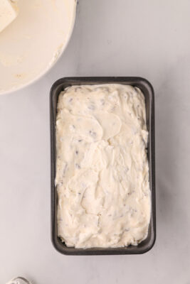 Ice cream mixture is spread in a loaf pan.