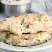 Parmesan ranch chicken tenders served on a late. Garnished with herbs.