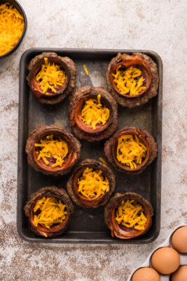 Shredded cheddar cheese added to the center of the sausage bowls.