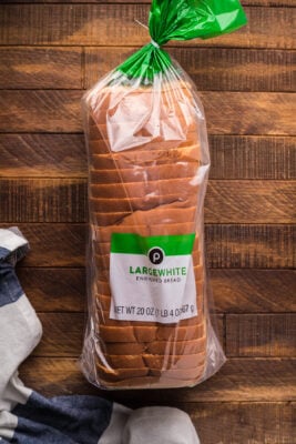Packaged loaf of bread on a wooden table.