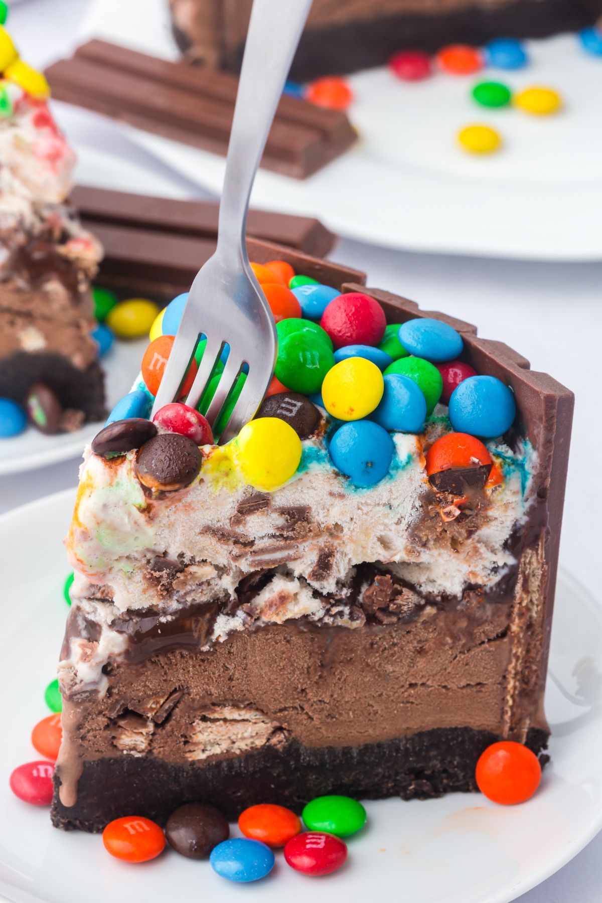 A fork taking a piece out of the Kit Kat ice cream cake.