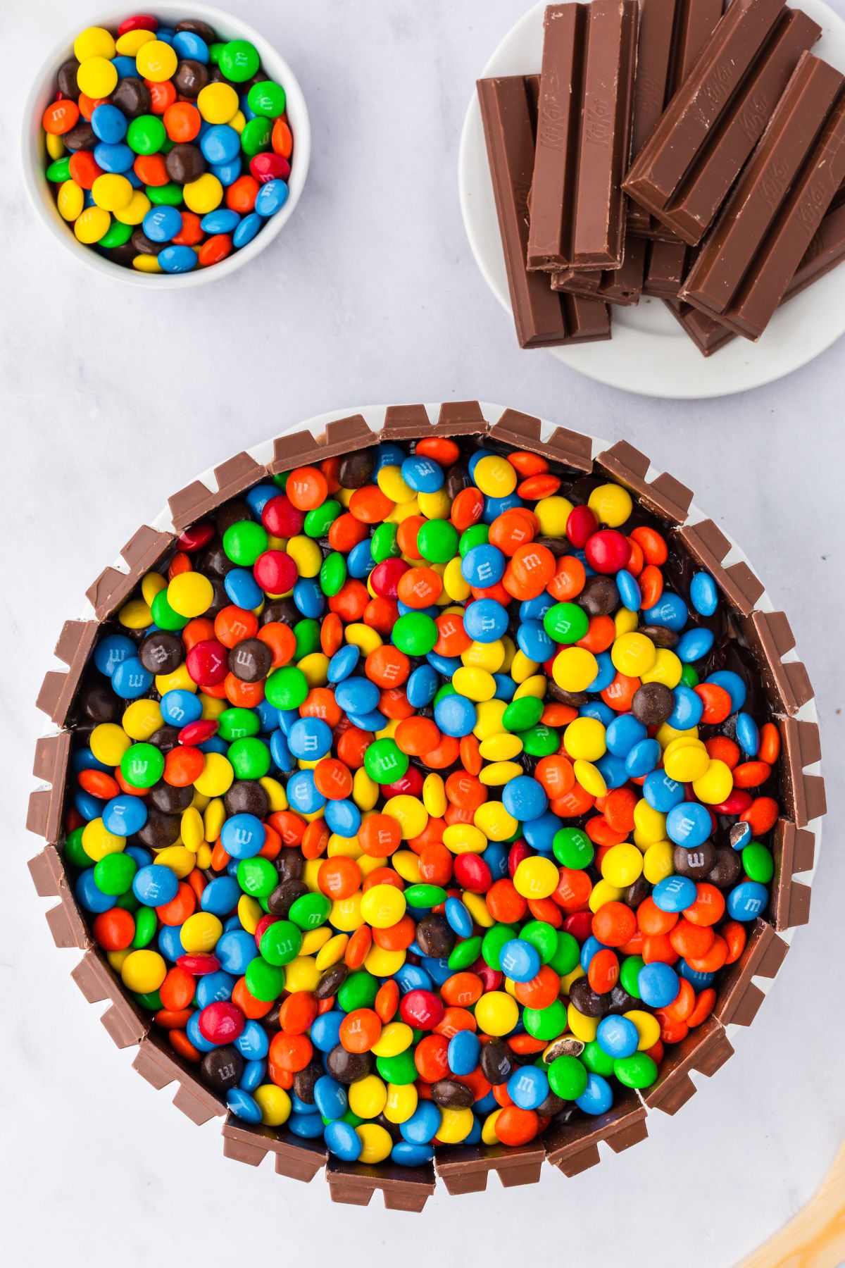 M&Ms added to the top of the ice cream cake.
