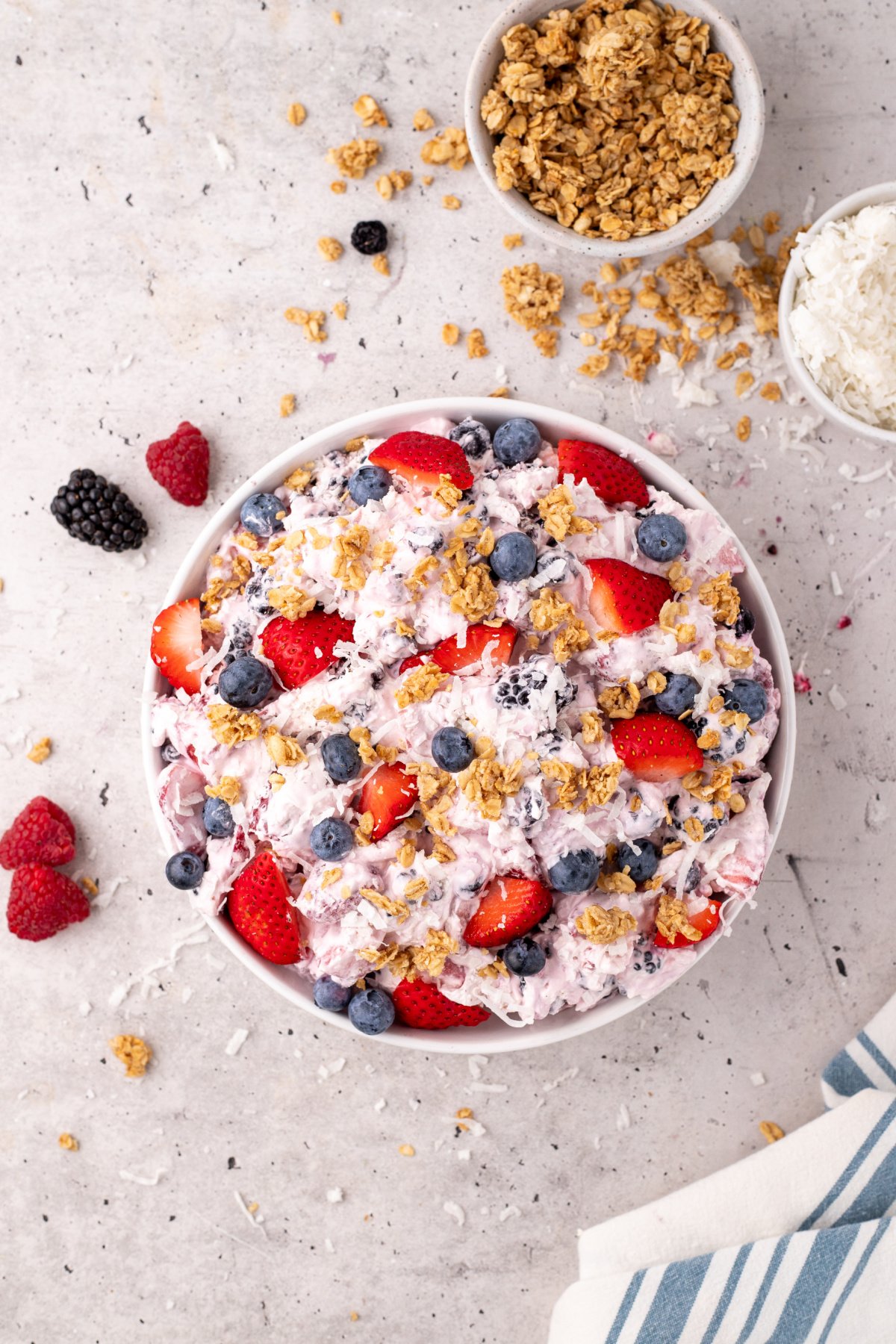 The cheesecake mixture combined into the bowl of berries.