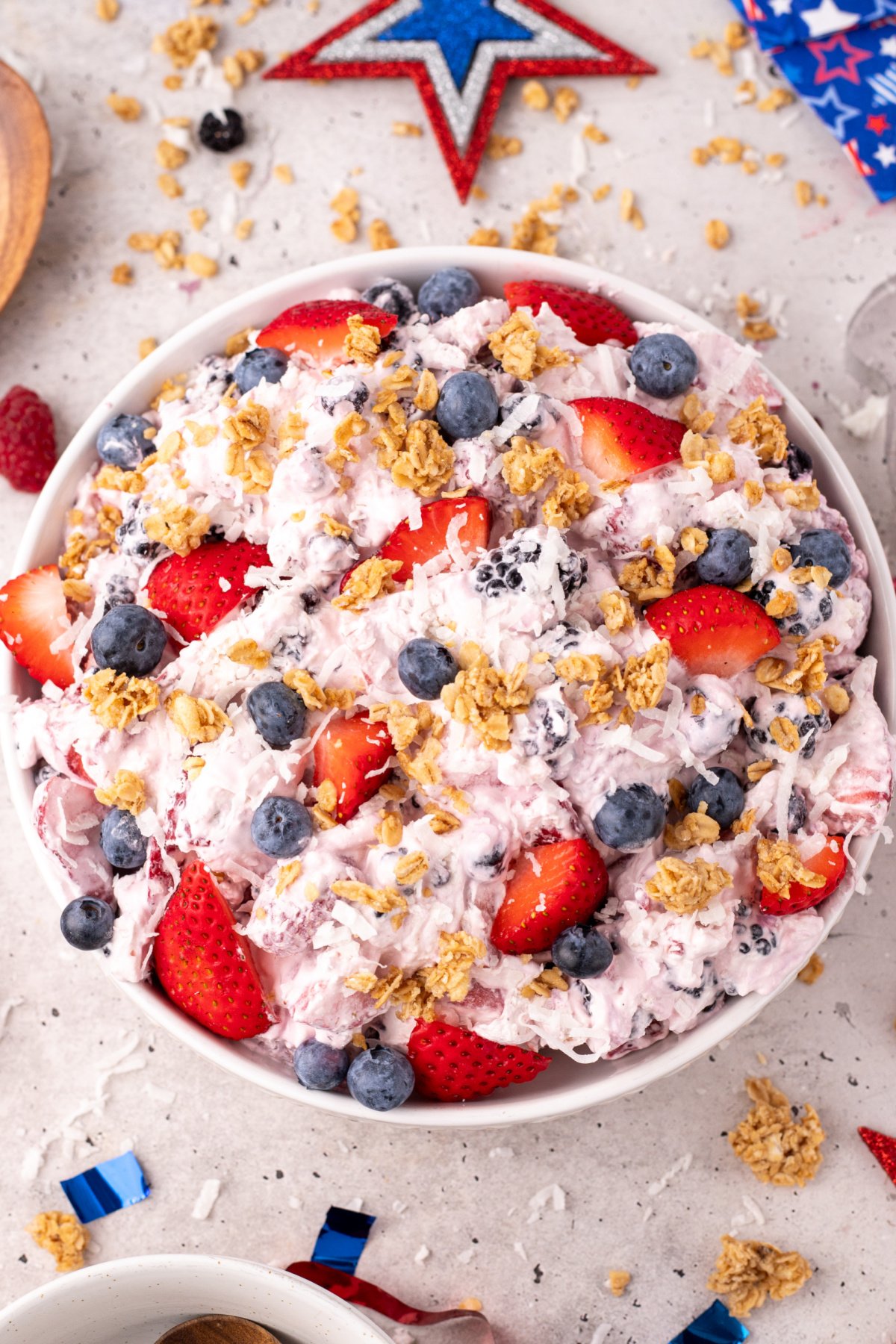 Strawberries, blackberries, blueberries, and raspberries mixed into cheesecake filling with lemon zest and granola.