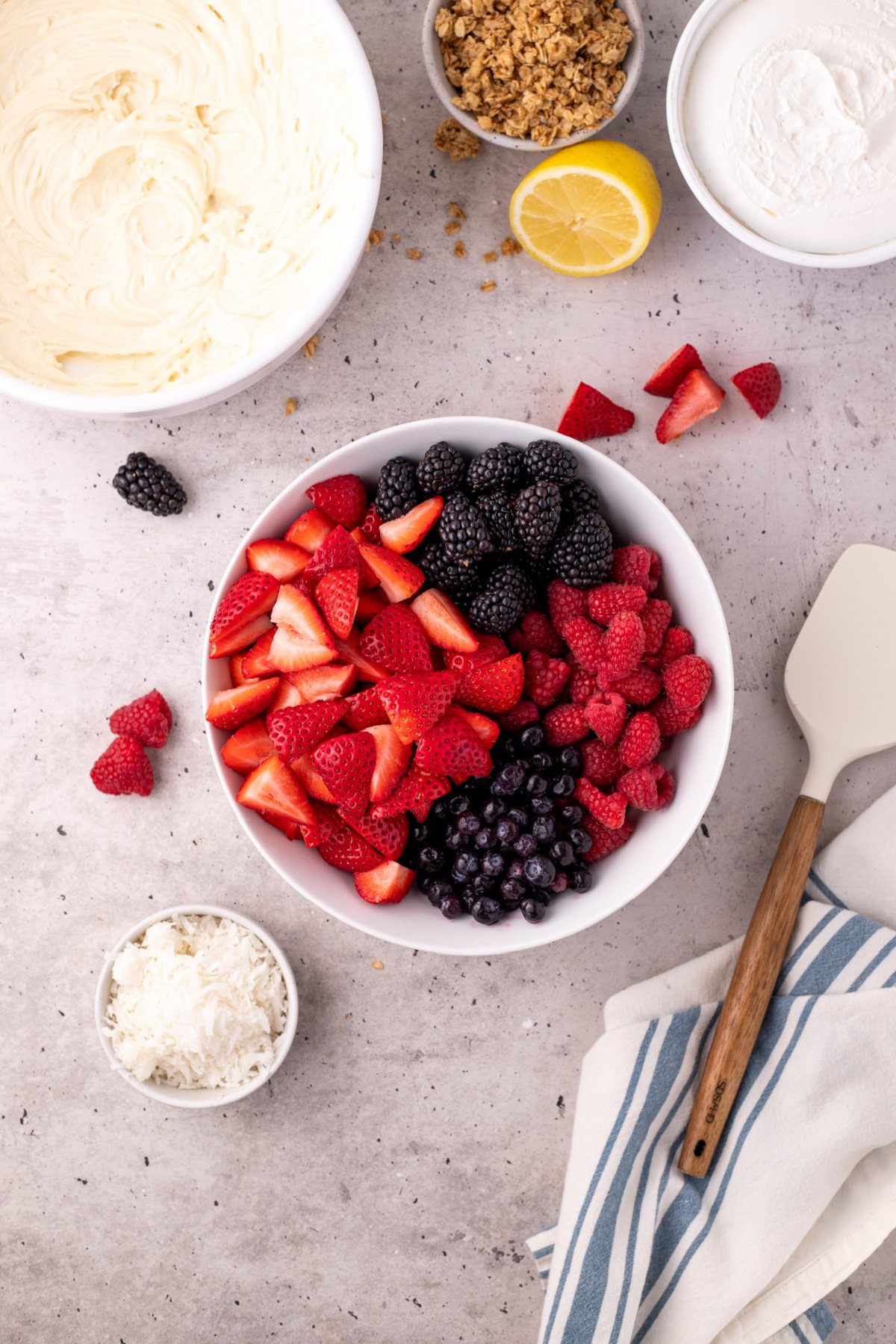 All the berries in a bowl with lemon juice in it.