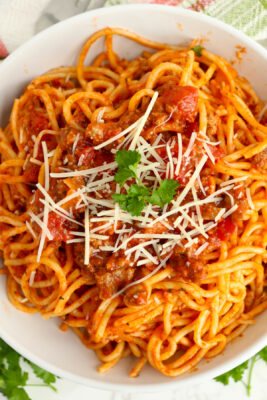 School cafeteria spaghetti served in a round-white bowl.