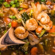 Shrimp Chop Suey being held by a wooden spoon.