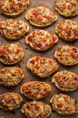 Overhead photo of Cheese bruschetta on a tray fresh from the oven. Bake in the oven for 12-15 minutes at 350 degrees.