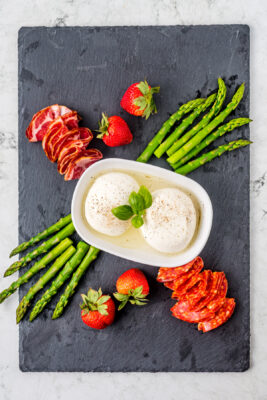 Burrata cheese placed in a small white container.