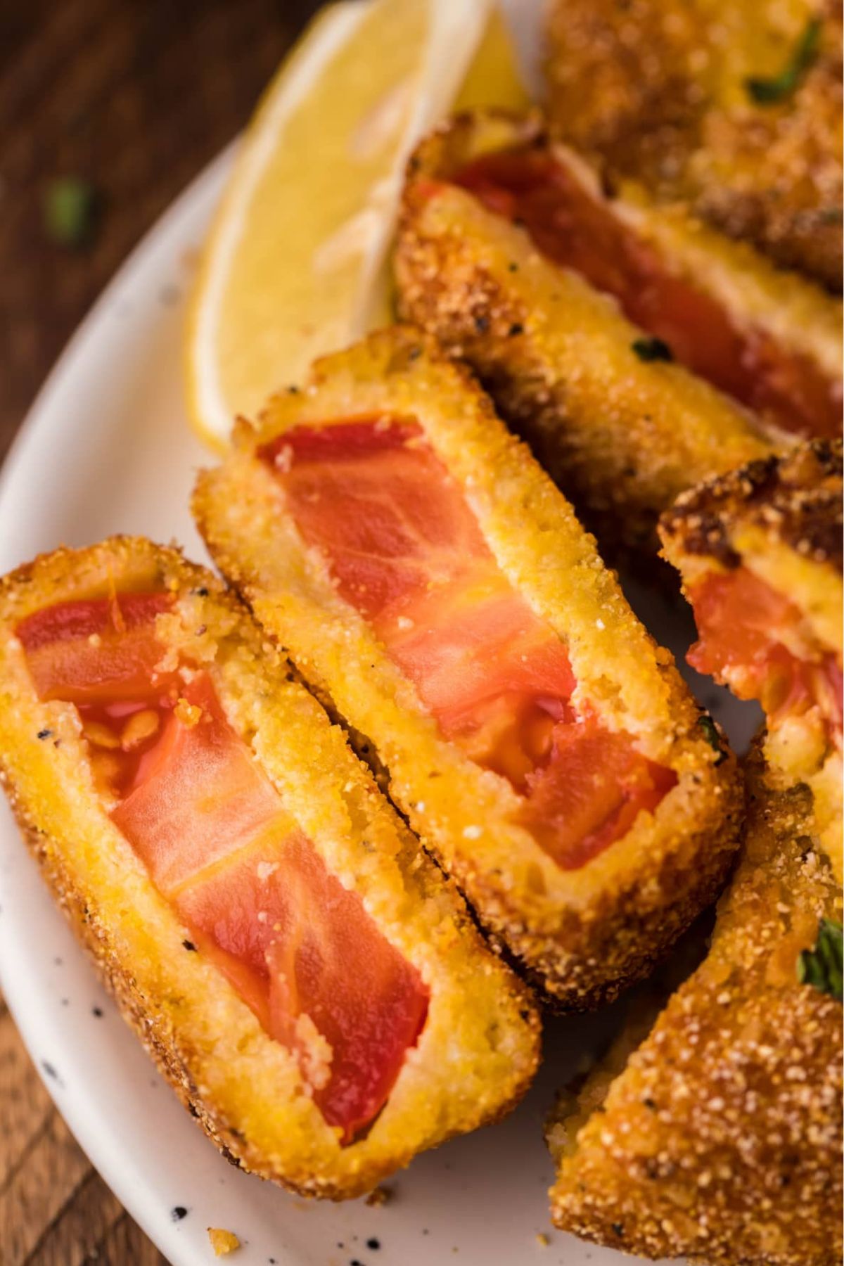 Tomato slices with a breading cut open showing the middle.