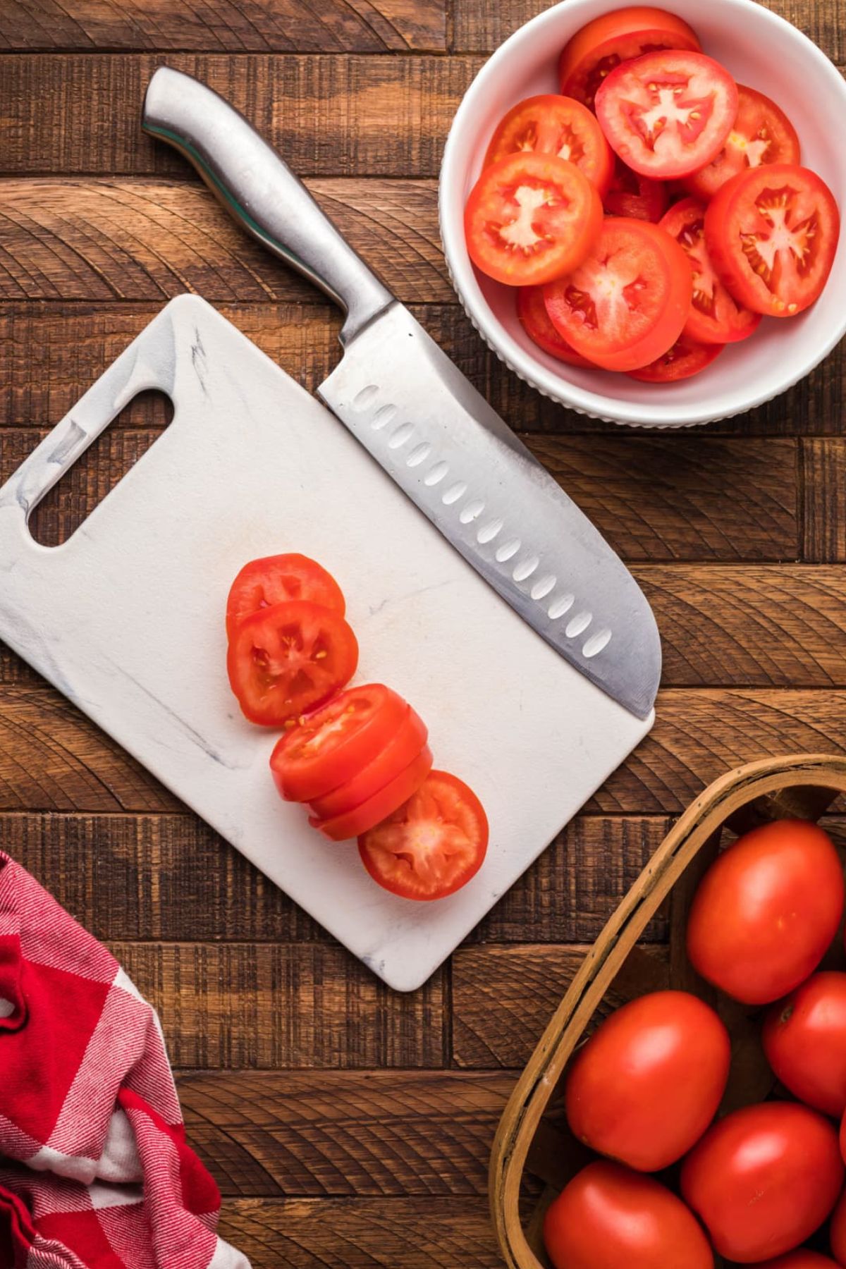 Tomatoes sliced on a cutting board.