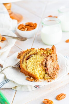closeup of a slice of cake on a white plate with a fork lying down on the plate