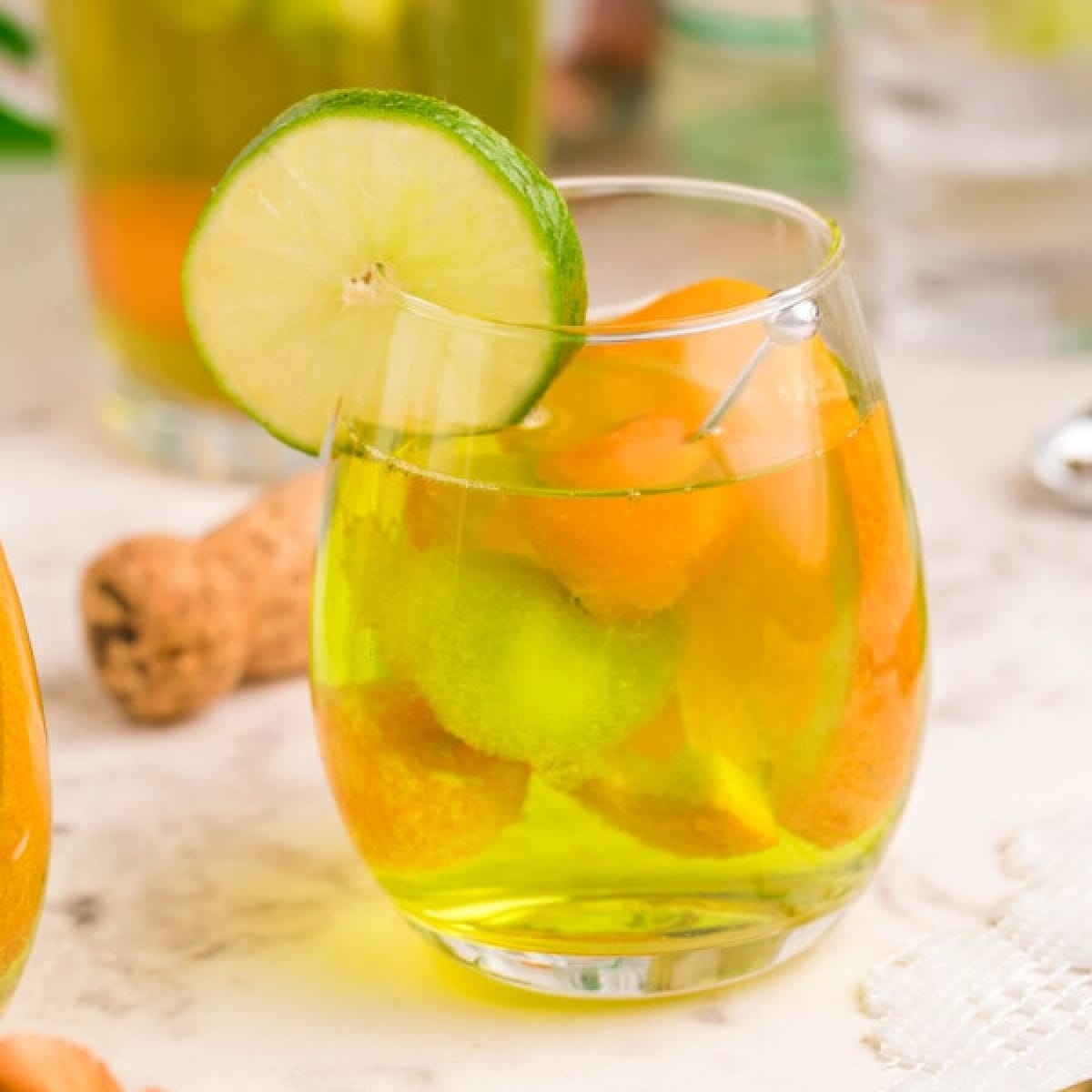 Glass of Moscato Sangria with Melon and a lime wedge on rim of glass