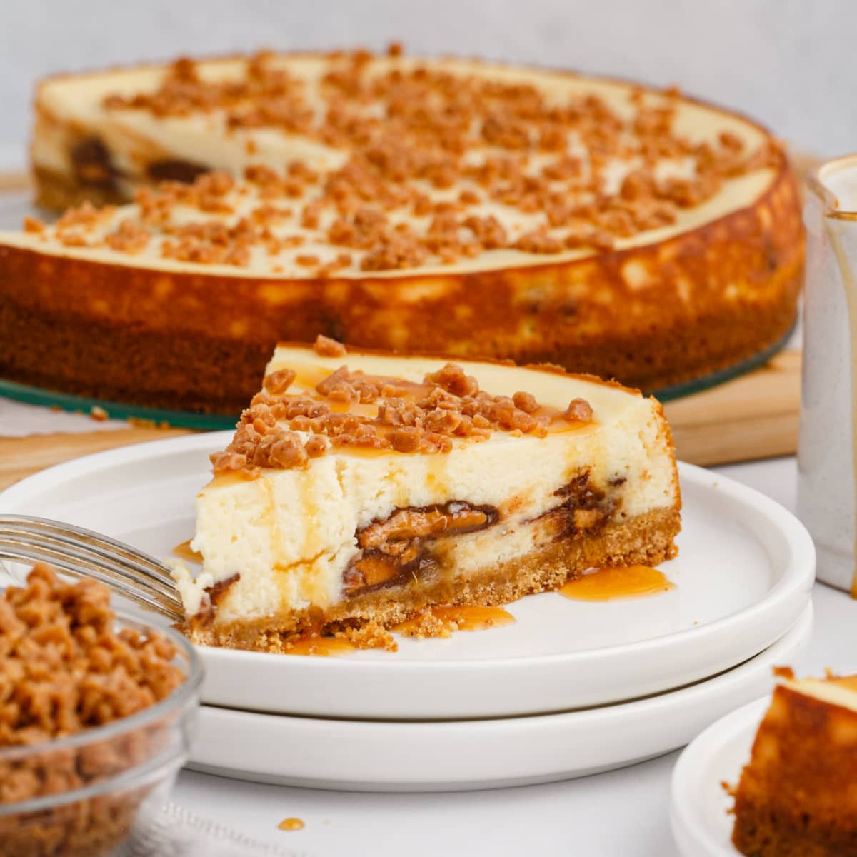 Heath Bar Cheesecake with slice taken out resting on a plate 
