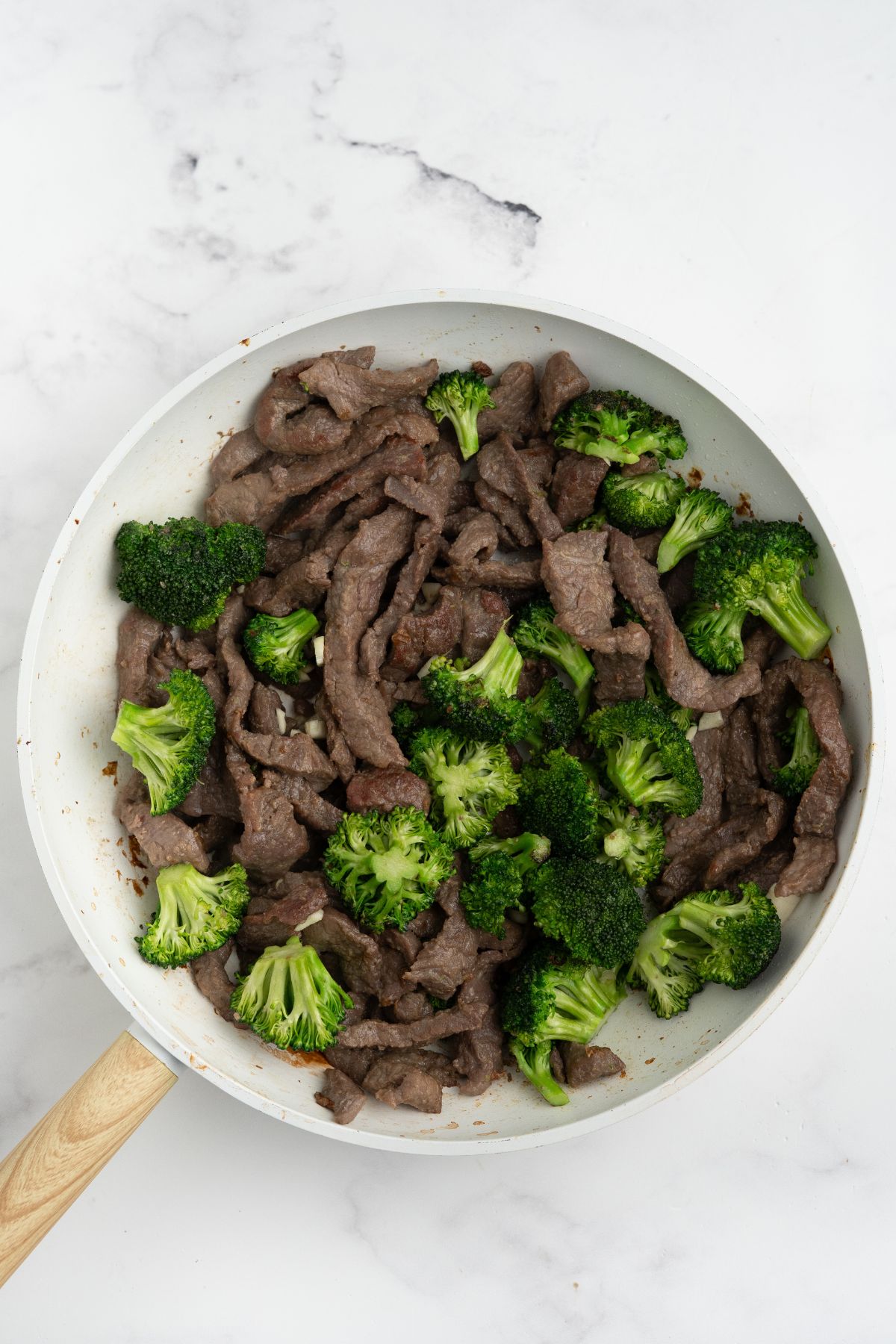 The cooked beef added back to the skillet.