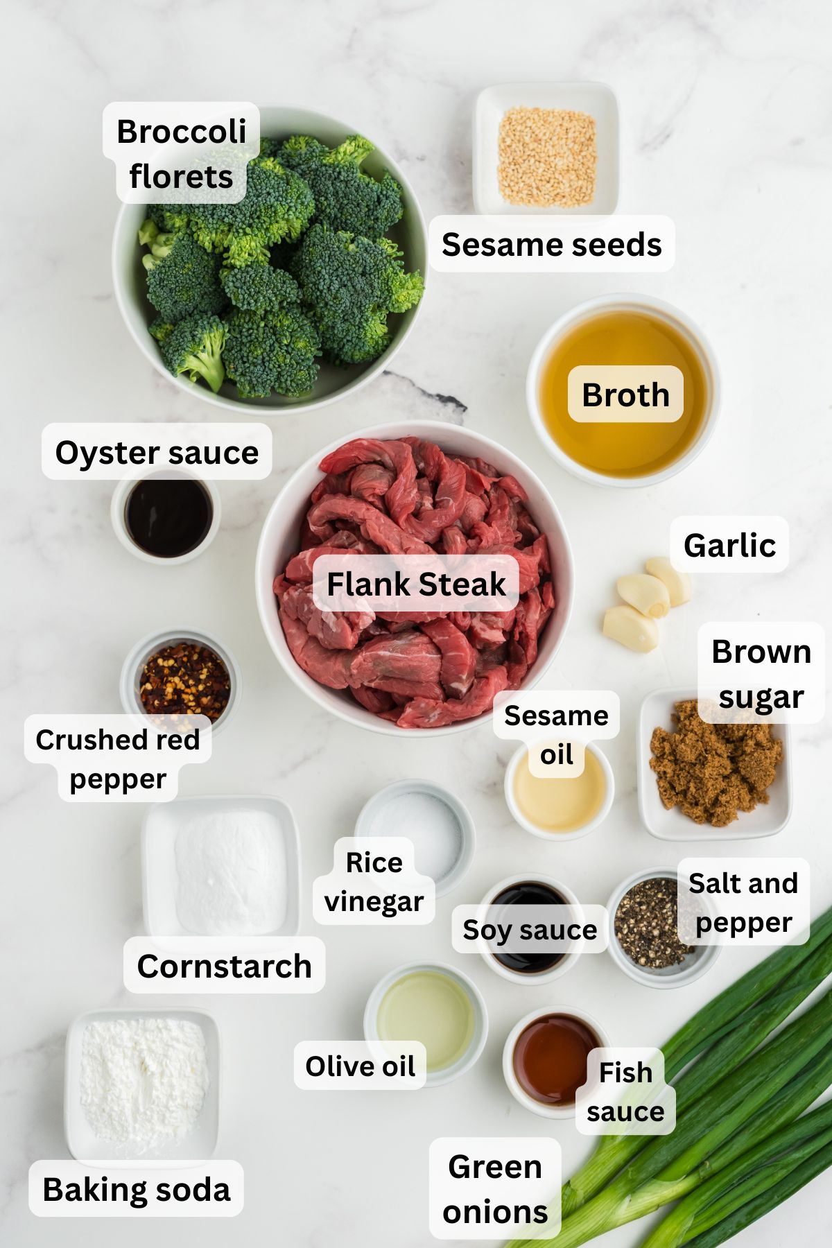 Ingredients for beef with garlic sauce in bowls on a table.