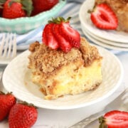 Cream cheese stuffed french toast on a plate with strawberries on top.