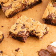 Nutella brookies laid directly on a cutting board and one in the middle is missing a bite.