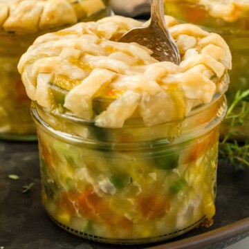 A spoon scooping up some of mini chicken pot pies.
