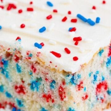 Piece of cake with red white and blue sprinkles and funfetti filled in the middle.
