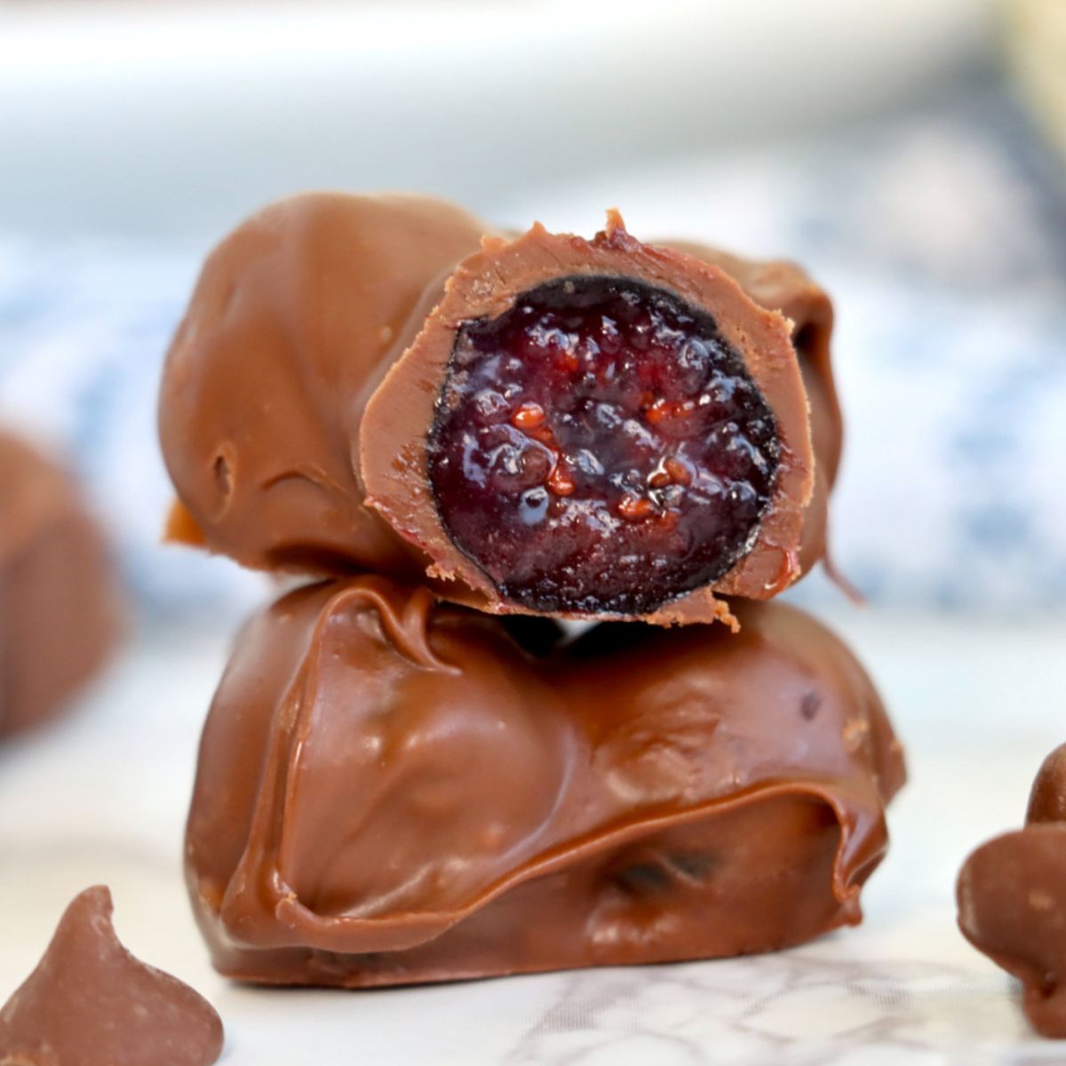 fresh blueberries covered in rich chocolate cut in half showing inside of blueberry