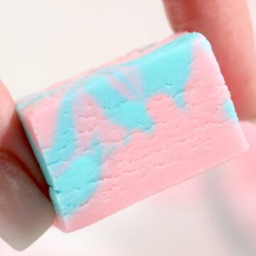 A hand holding a piece of fudge.