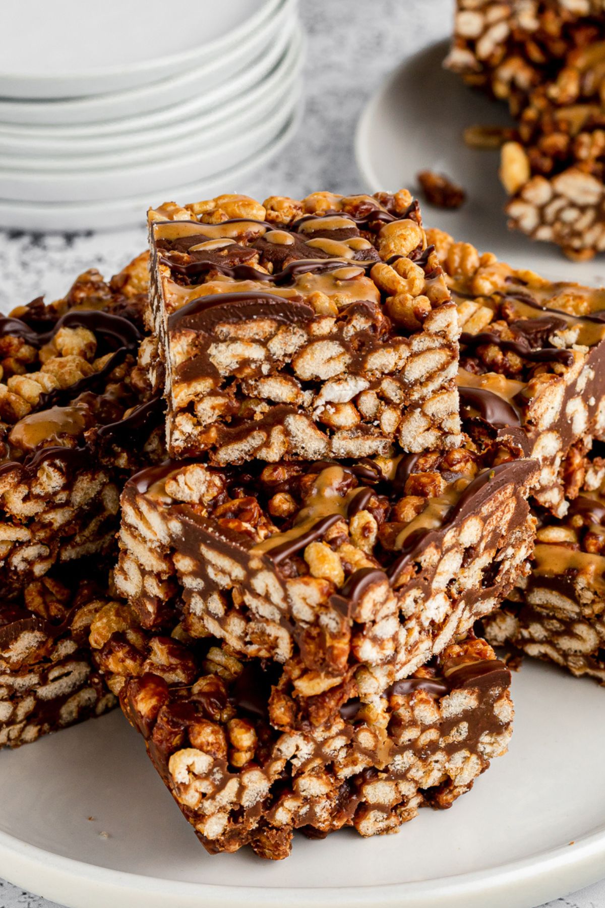 Golden crisp marshmallow cereal bars stacked on top of one another.