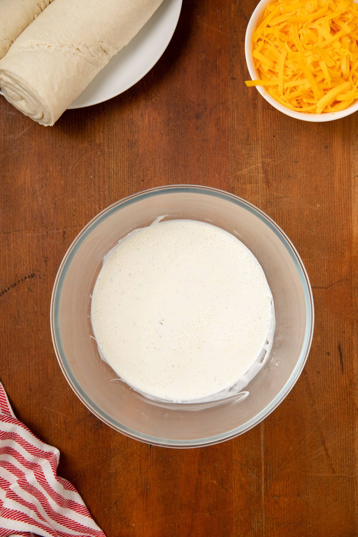 Mayo, ranch dressing and milk in a small bowl.