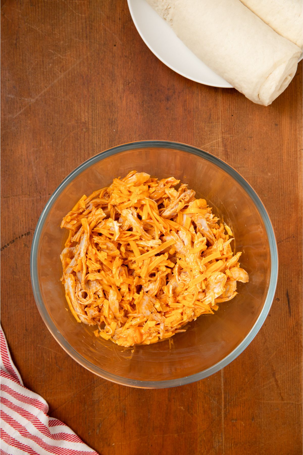 Shredded chicken in a glass bowl. 