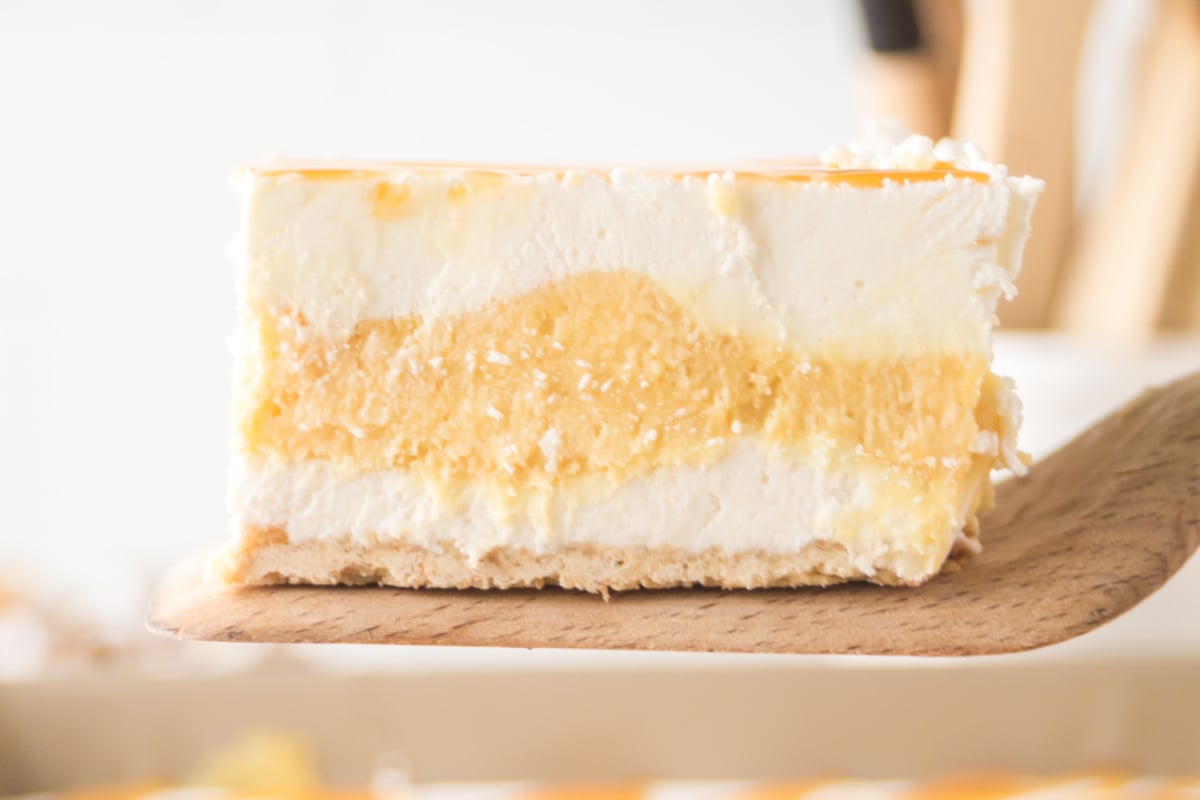 A slice held in the air being served.