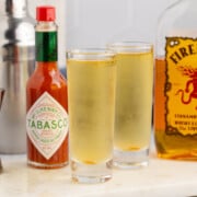 Fireball Shot with another, tobasco sauce and Fireball whisky on table.