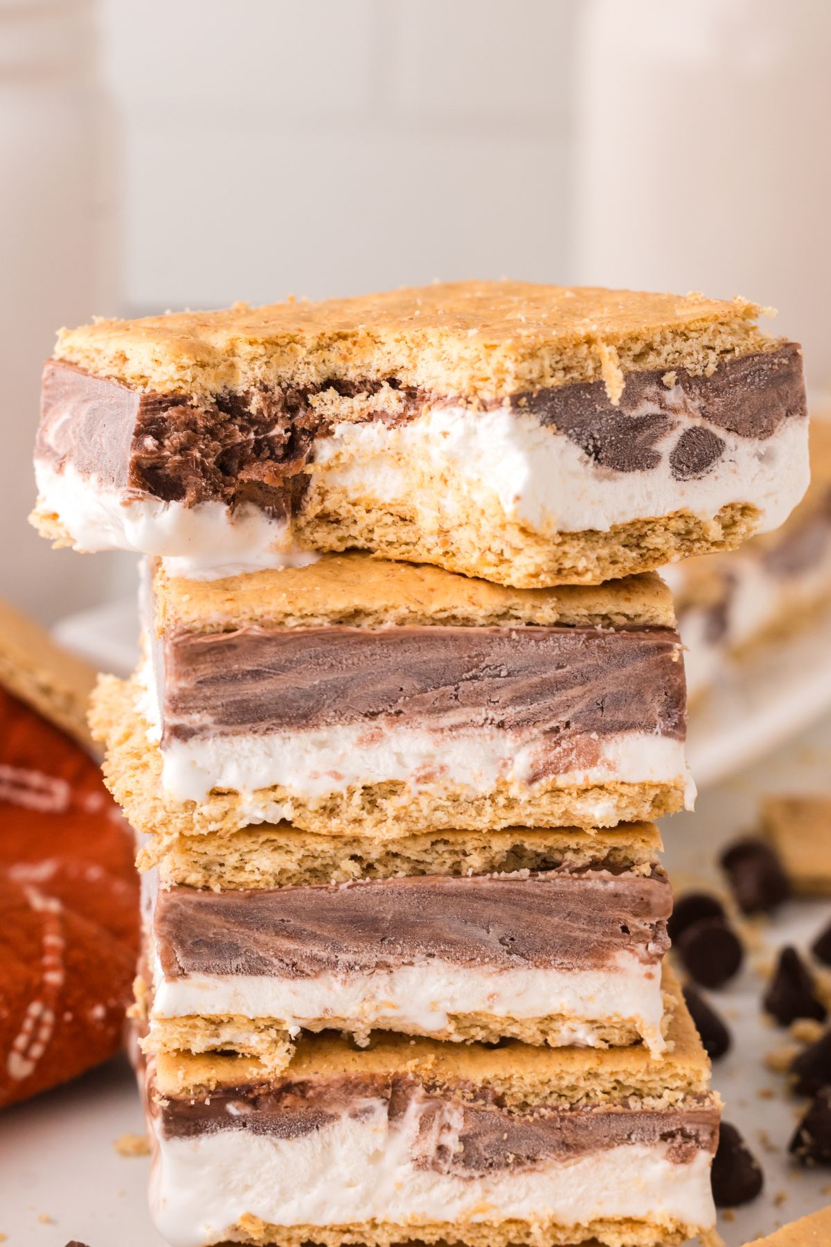 Frozen s'mores stacked with a bite taken off the top s'more.