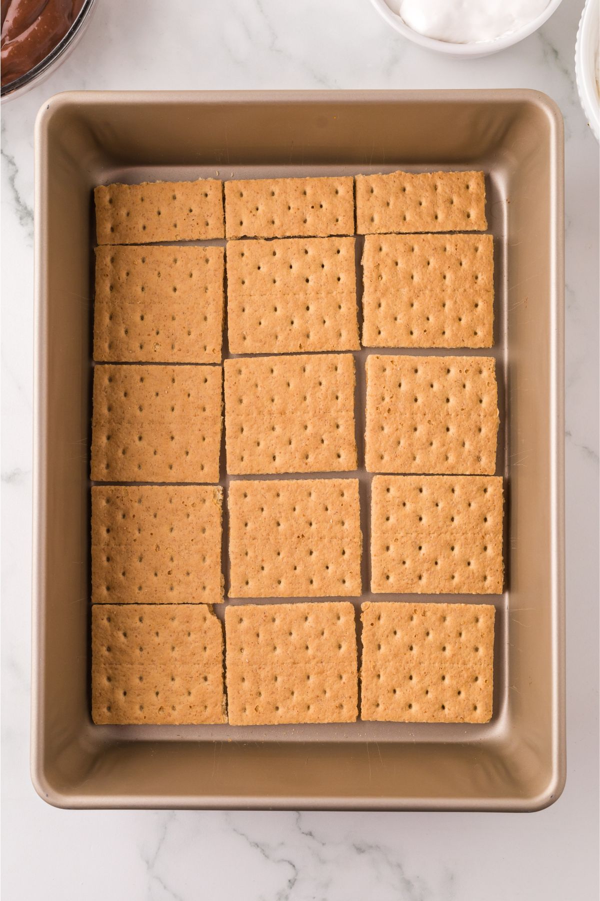 Layer of graham cracker squares into the bottom of the prepared pan.