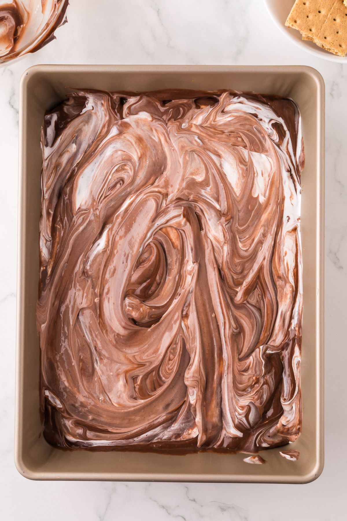 Spread marshmallow mixture on top of the crackers, and then chocolate pudding on top of that.