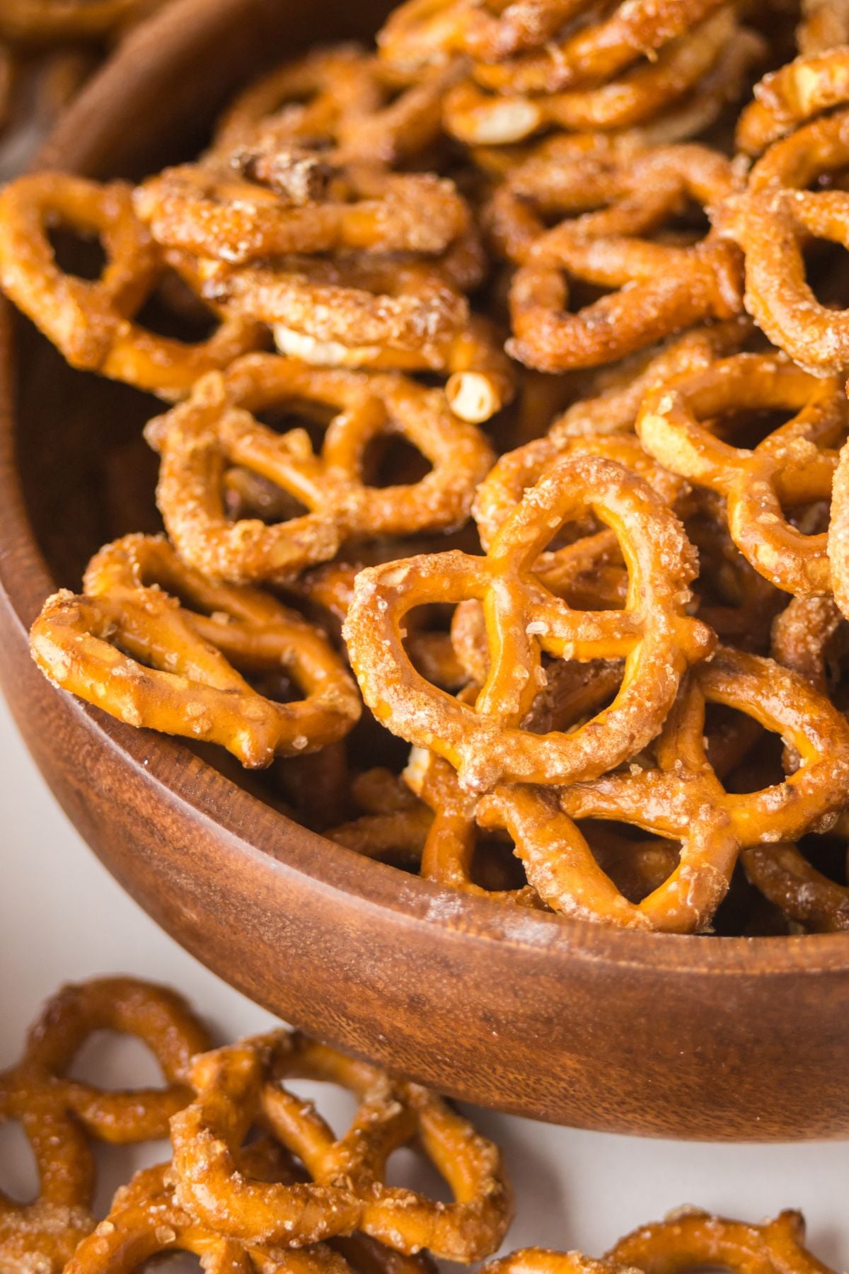 This sweet and salty maple pretzels snack is piled high in a wooden bowl.