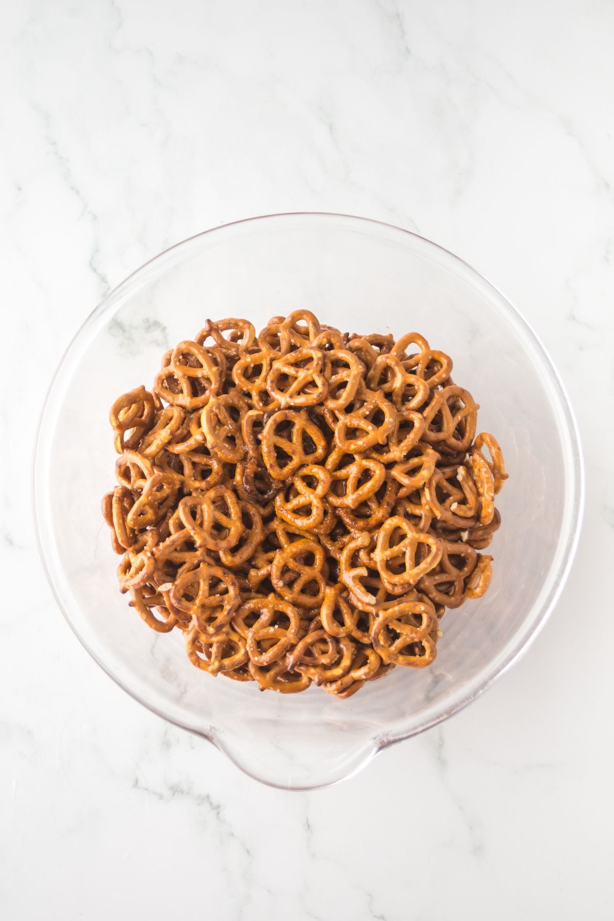 A bowl full of coated pretzels.
