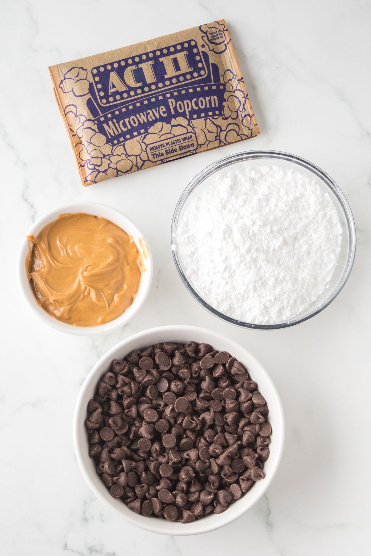 Ingredients to make muddy buddy popcorn on a table.