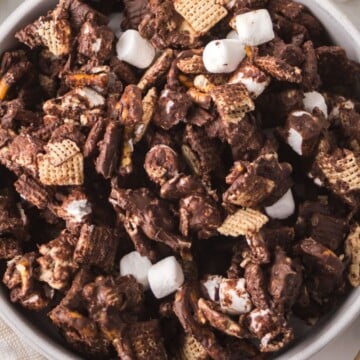 A bowl full of snack mix.
