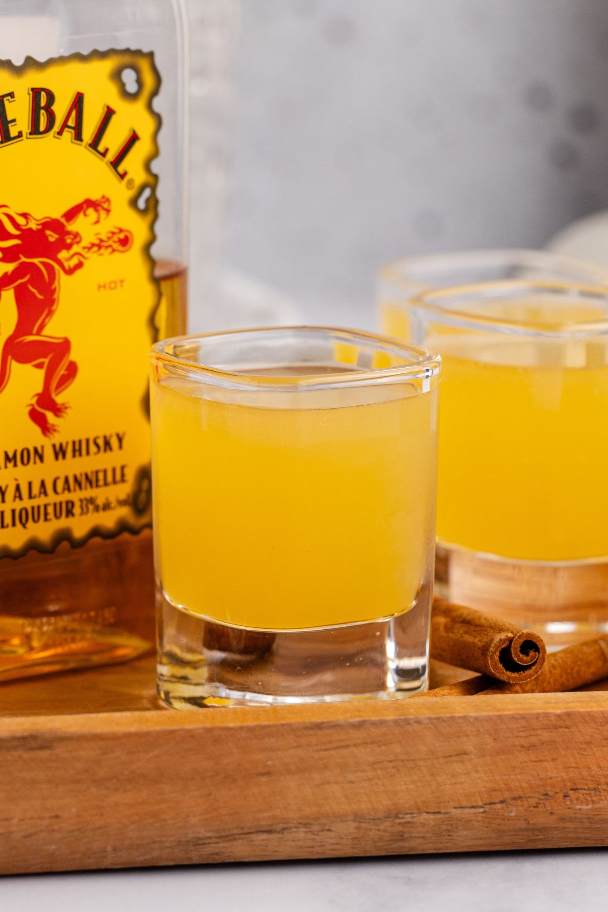 Shots on serving tray with bottle of whiskey.