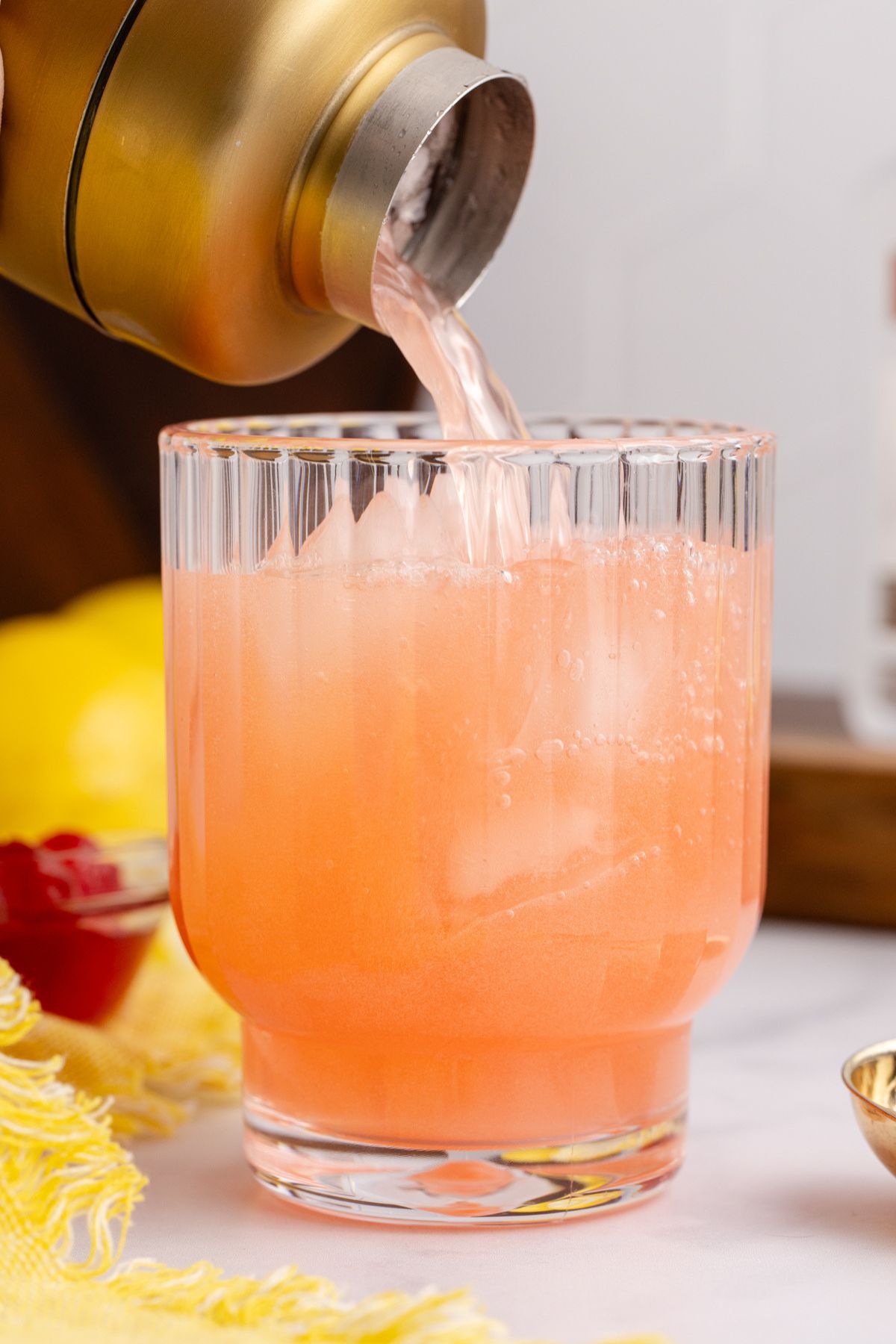shaken cocktail poured over ice in a glass.