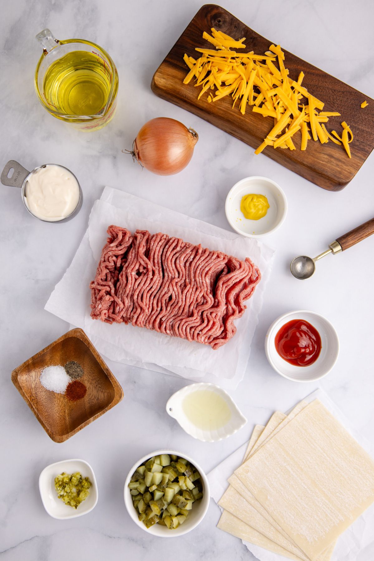 Ingredients for Big Mac egg rolls on a table before preparing.