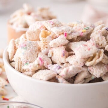 A serving of birthday cake chex mix in a bowl.